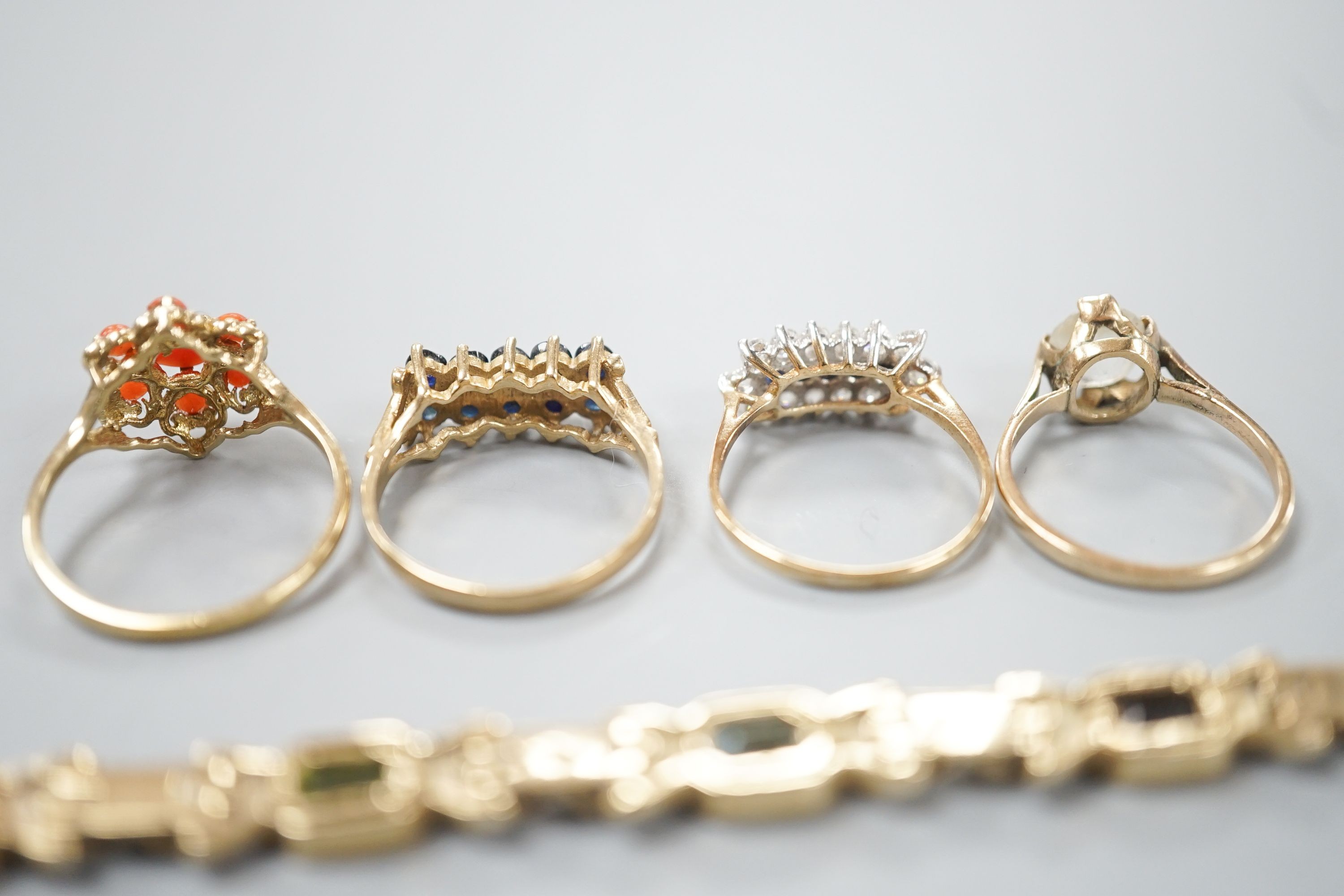 A modern 9ct gold and gem set bracelet and four assorted 9ct gold dress rings, gross 24.8 grams